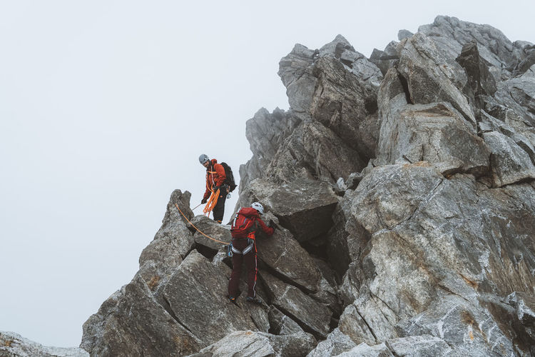 Low angle view of man climbing mountain