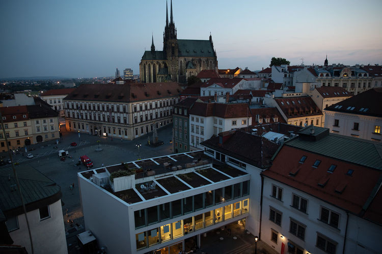 High angle view of buildings in town against sky at dusk