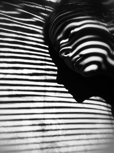 Close-up of shadow on bed
