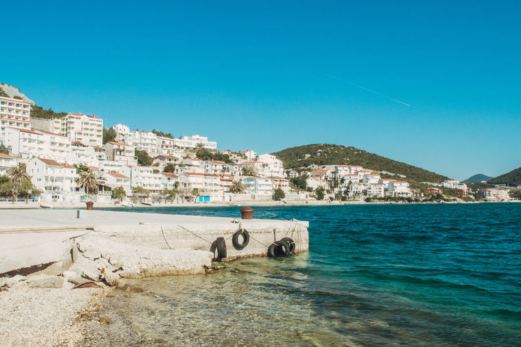 Buildings by sea in city