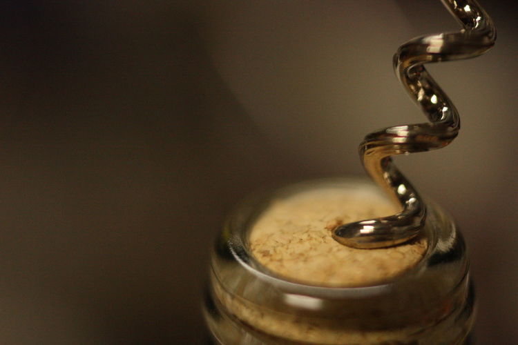 Close-up of corkscrew on wine bottle