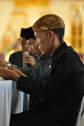 Old man praying in some ceremony