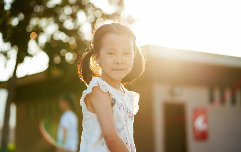 Portrait of cute girl standing outdoors