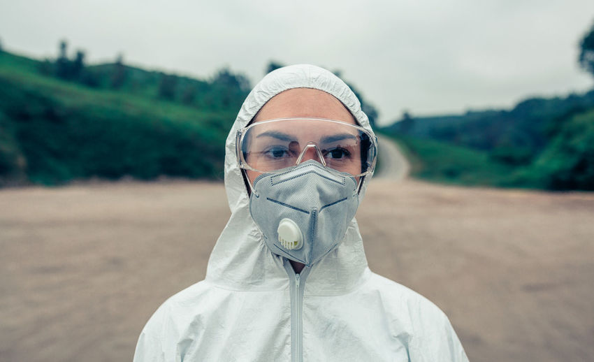 Female scientist wearing protective workwear while standing outdoors