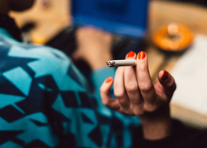 Close-up of woman hand holding cigarette