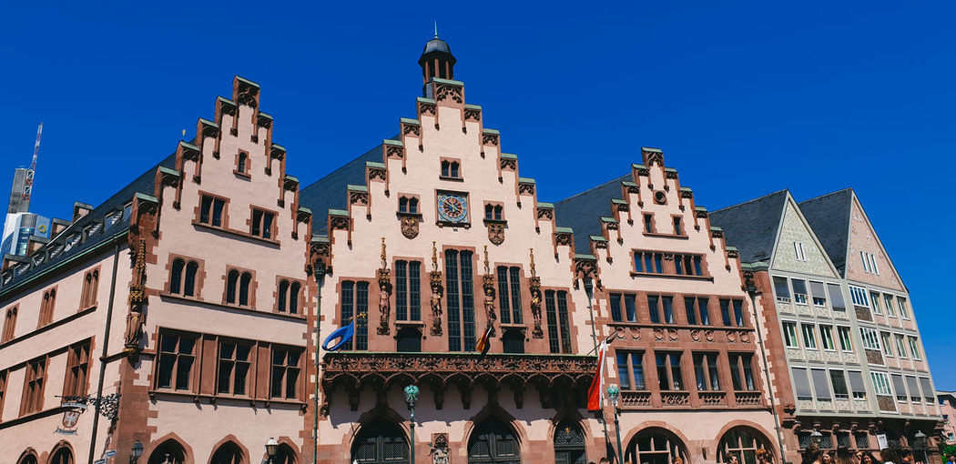 Low angle view of buildings against blue sky of frankfurt city