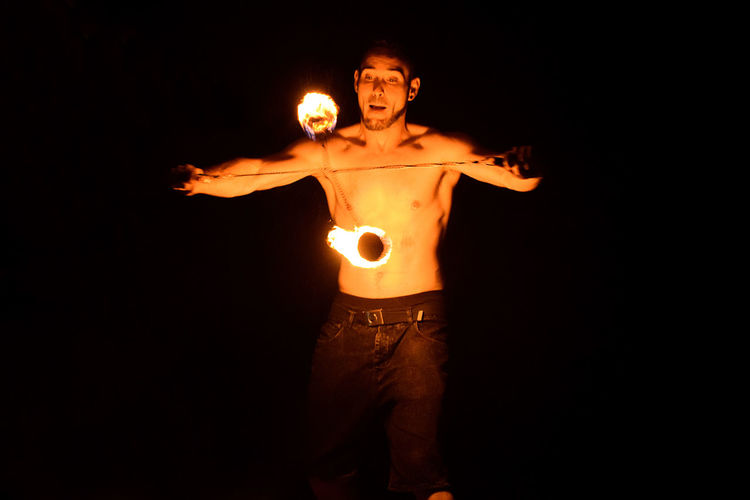 Man playing with fire at night