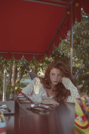 Portrait of a young woman sitting outdoors