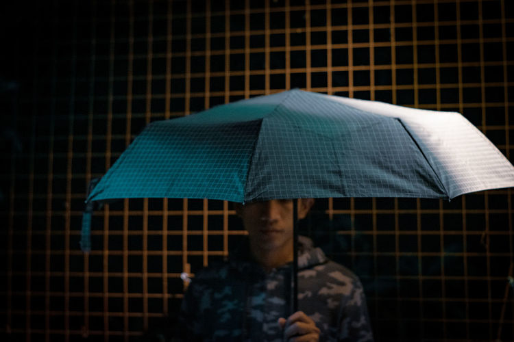 Portrait of man with umbrella