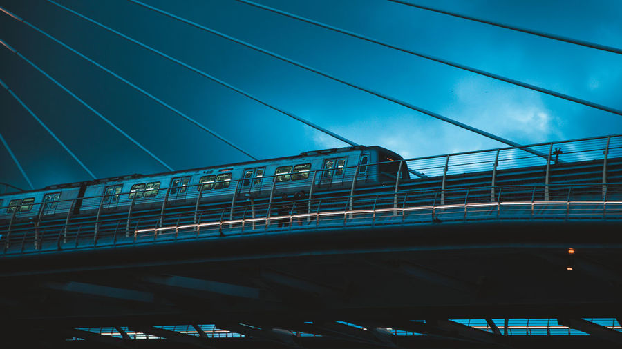 Low angle view of train on bridge against sky