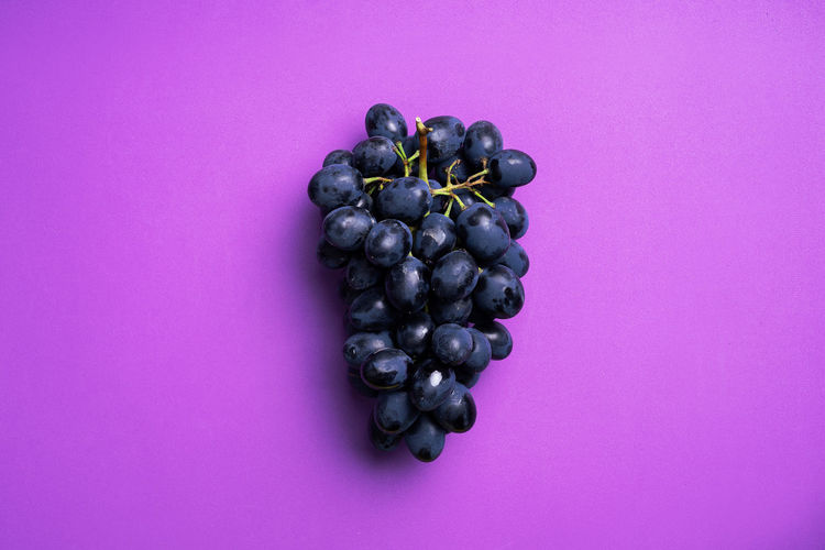 Close-up of grapes over black background