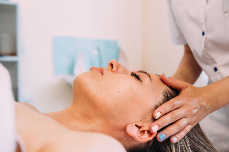 Cosmetologist does facial massage for woman. beauty skin care