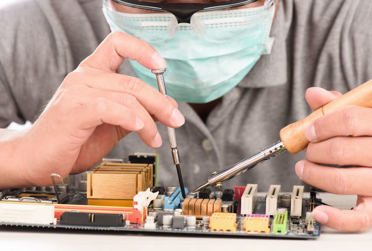 Close-up of engineer repairing circuit board