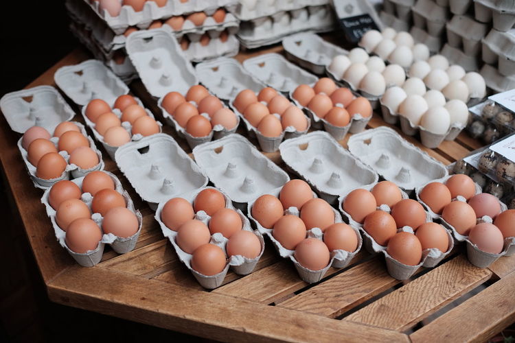High angle view of eggs in cartons on table