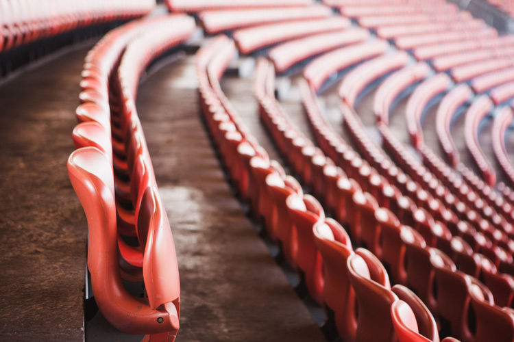 Rows of red seats in sports stadium