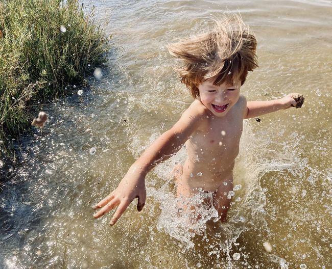 Boy playing in water at beach