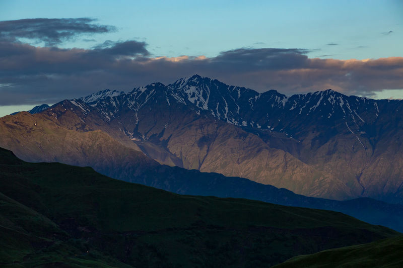 Mountains of chechnya. scenic view of snowcapped mountains against sky during sunset