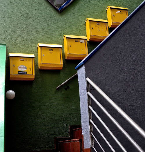 Low angle view of mailboxes on wall by steps