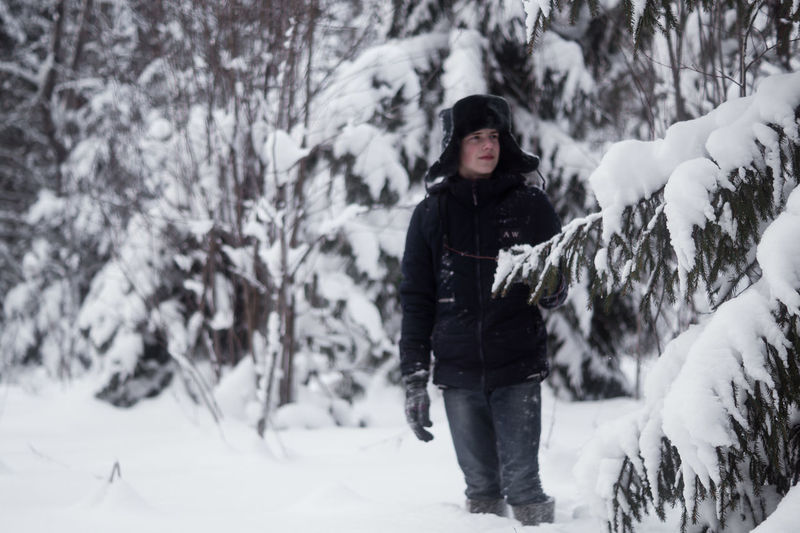 Full length of woman standing on snow covered land