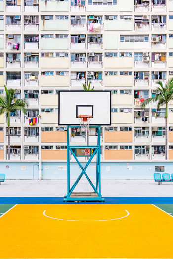 Basketball hoop against buildings in city