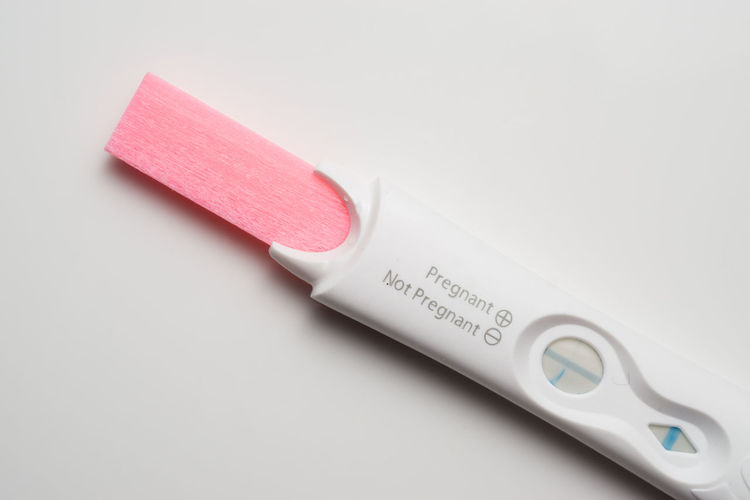Directly above shot of pregnancy test on background