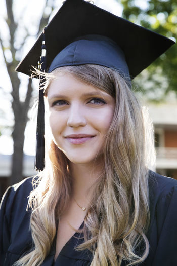 Portrait of smiling woman in graduation gown