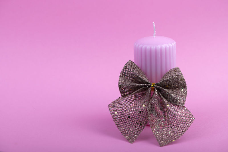 Close-up of christmas decoration against pink background