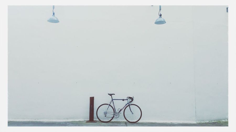 Bicycle leaning against wall