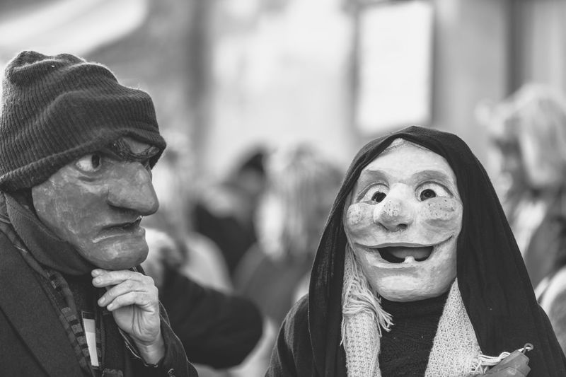 Ancient carnival of sauris. traditional wooden masks. black and white. italy