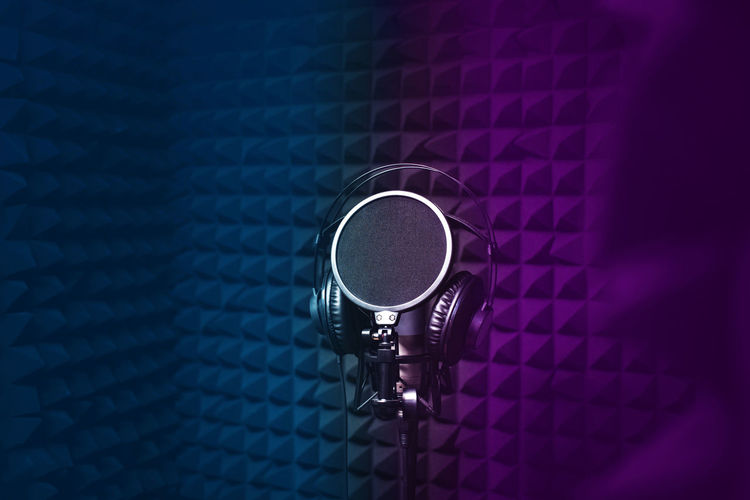 Microphone, headphones for singing, recording studio, black noise-cancelling walls, background