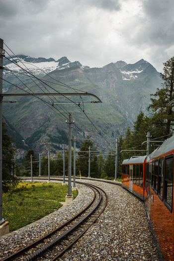 Railway and red train close up, gornergrat mountains. zermatt, swiss alps. adventure in switzerland.