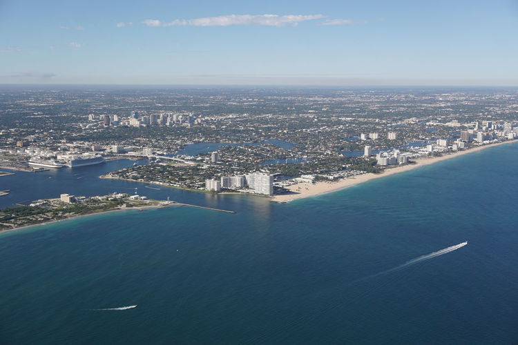 Scenic view of sea and residential district against sky
