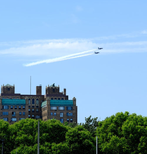 Low angle view of airplane flying against sky