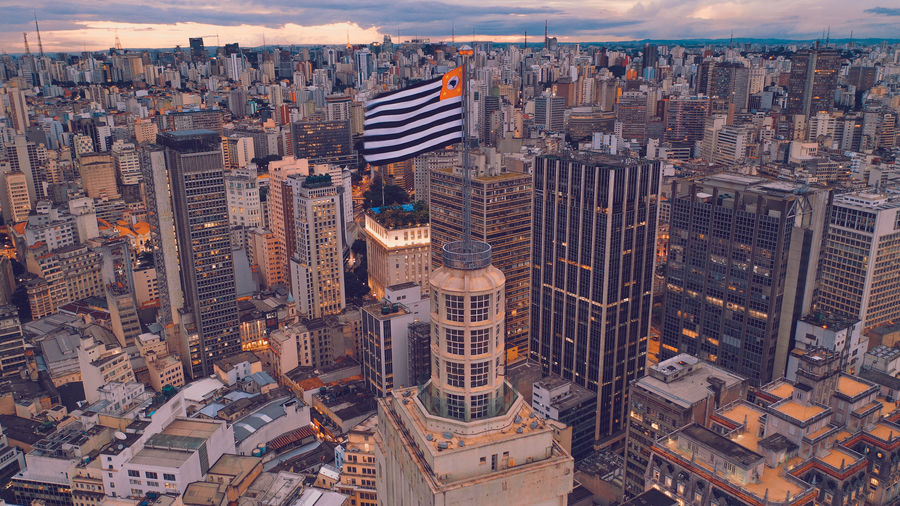 Aerial view of modern buildings in city at dusk