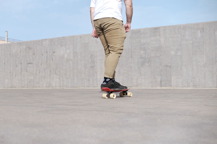 Young man riding skateboard on the street