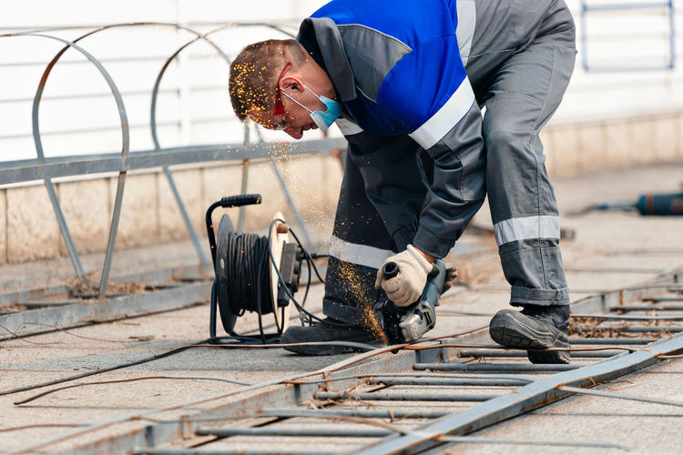 Low section of man working on railroad station