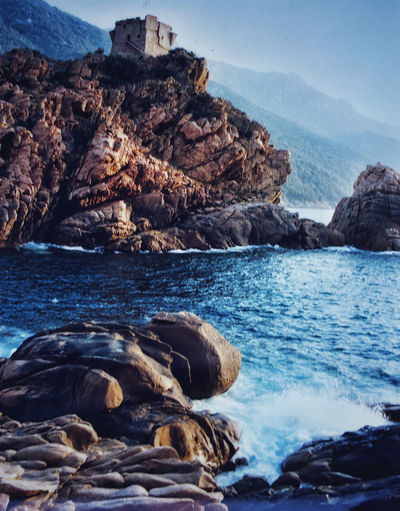 Scenic view of sea and rocks against sky