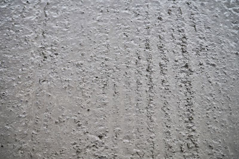 Full frame shot of water drops on concrete wall