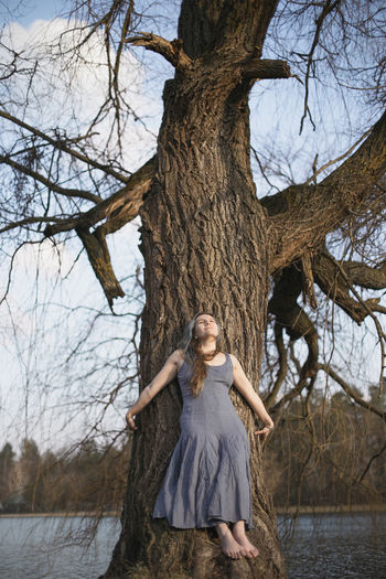 Leaning against willow tree scenic photography