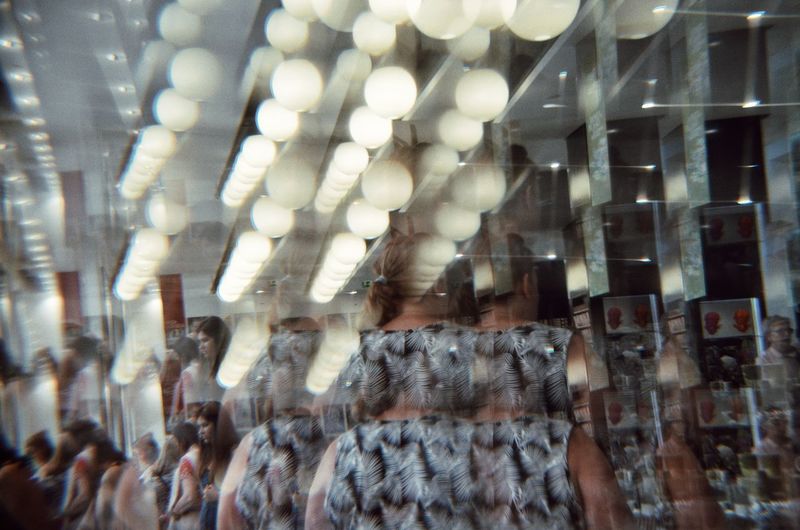 Digital composite image of people on illuminated ceiling