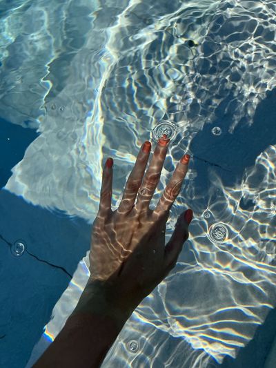 Cropped image of man swimming in pool
