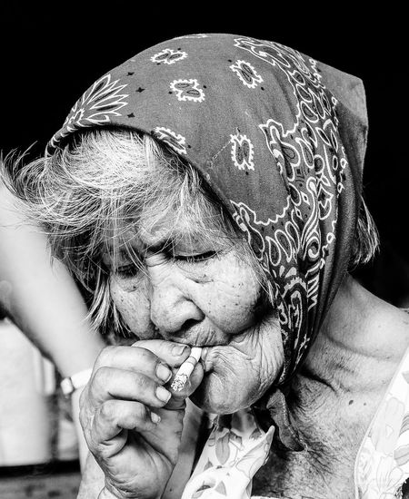 Close-up of senior woman smoking cigarette