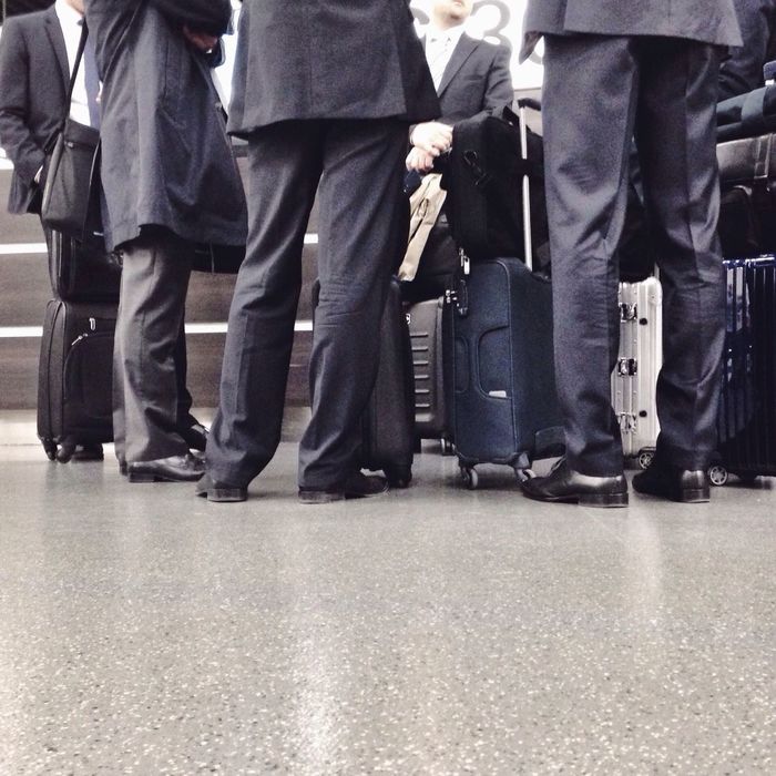 Low section of businessmen waiting at airport