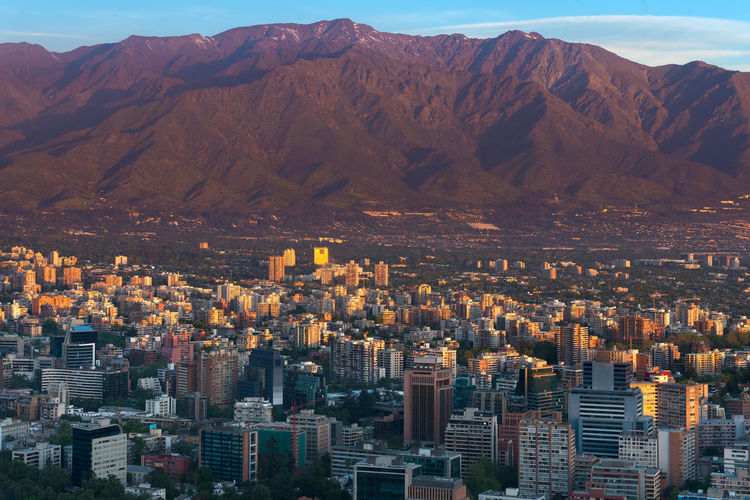 Panoramic view of providencia district with los andes mountain range in santiago de chile.
