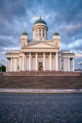 Facade of historic building against sky in city