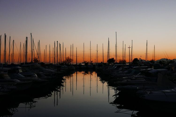 Sailboats in lake during sunset