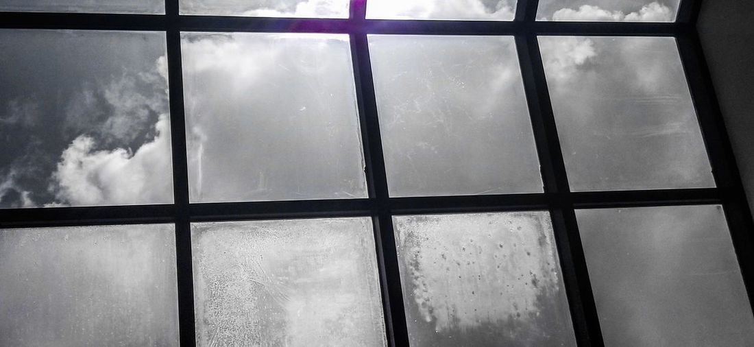 Low angle view of glass window in building