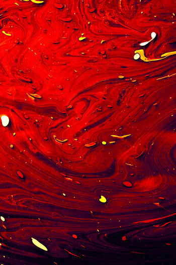 Full frame shot of water drops on red surface