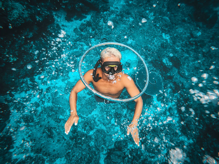 High angle portrait of woman swimming in sea