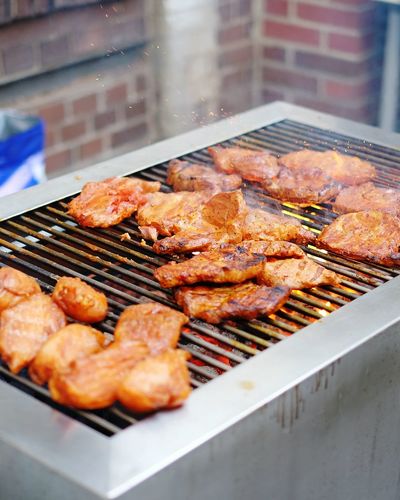 Close-up of meat grilling on barbeque outdoors